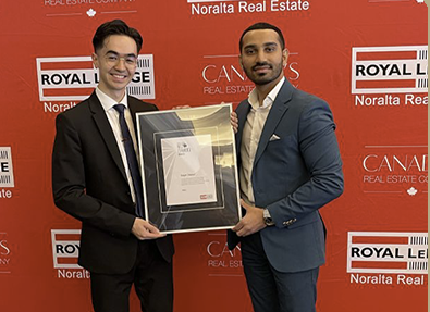 William Kabrall and Sagar Dasaur holding their framed award at Royal LePage Noralta