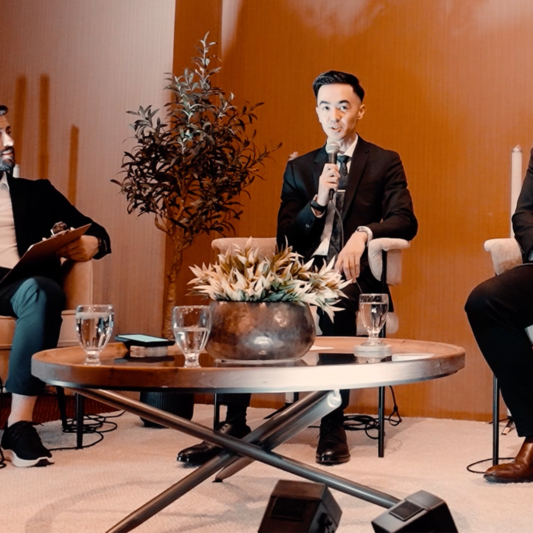 William Kabrall speaking with a microphone on an industry panel